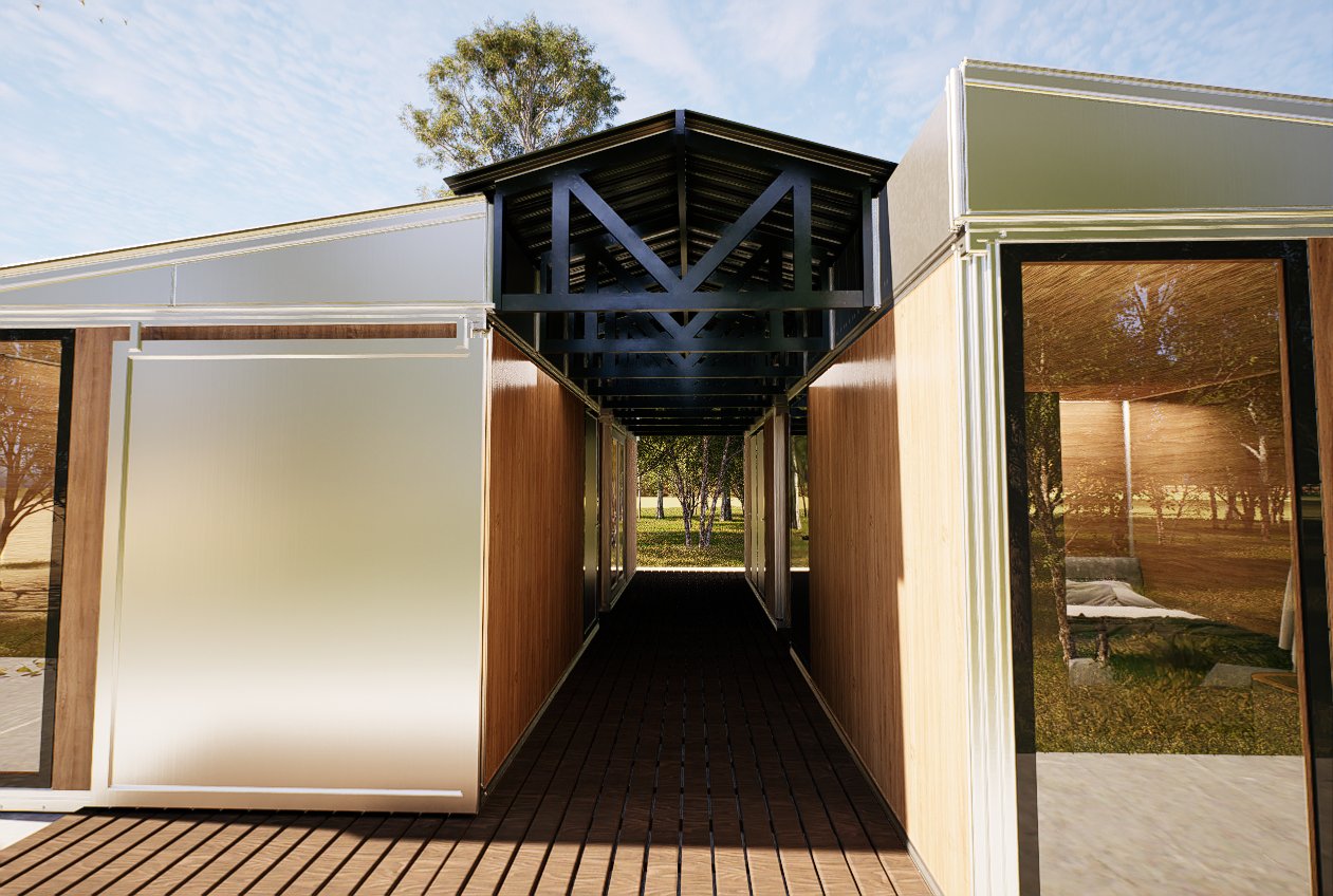 Breezeway between two joined Anyplace modules showing exposed gable structure, timber decking, sliding doors and surrounding landscape — the architectural junction detail of a multi-module deployment