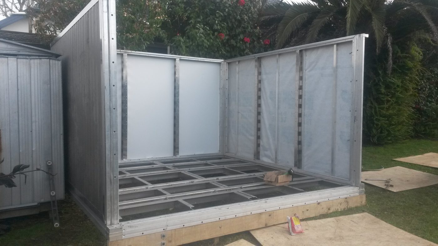 2016 proof-of-concept floor skeleton — early aluminum frame laid out on workshop floor showing the base structural geometry