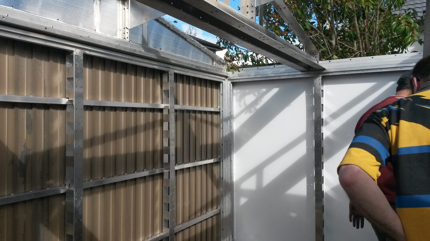 2016 workshop floor with proof-of-concept aluminum module being hand-built, parts and tools visible around the work area